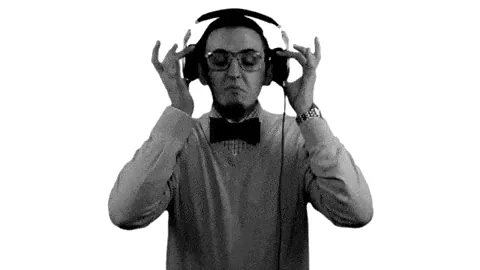 Man in a bow tie putting on headphones
